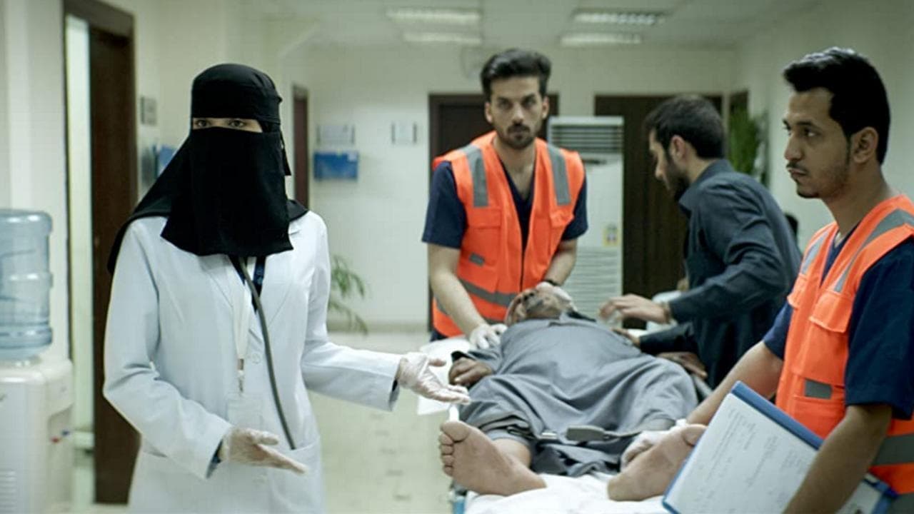 Dr. Maryam sees patients in the hospital, her face fully covered.