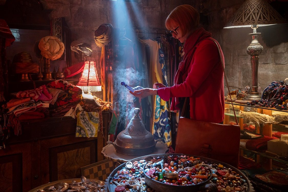 Tilda Swinton holds a blue bottle in a Turkish bazaar in 3,000 Years of Longing