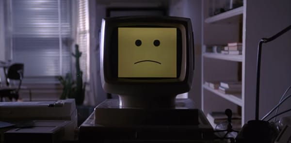 In the movie "Electric Dreams", a desktop computer displays a sad face.